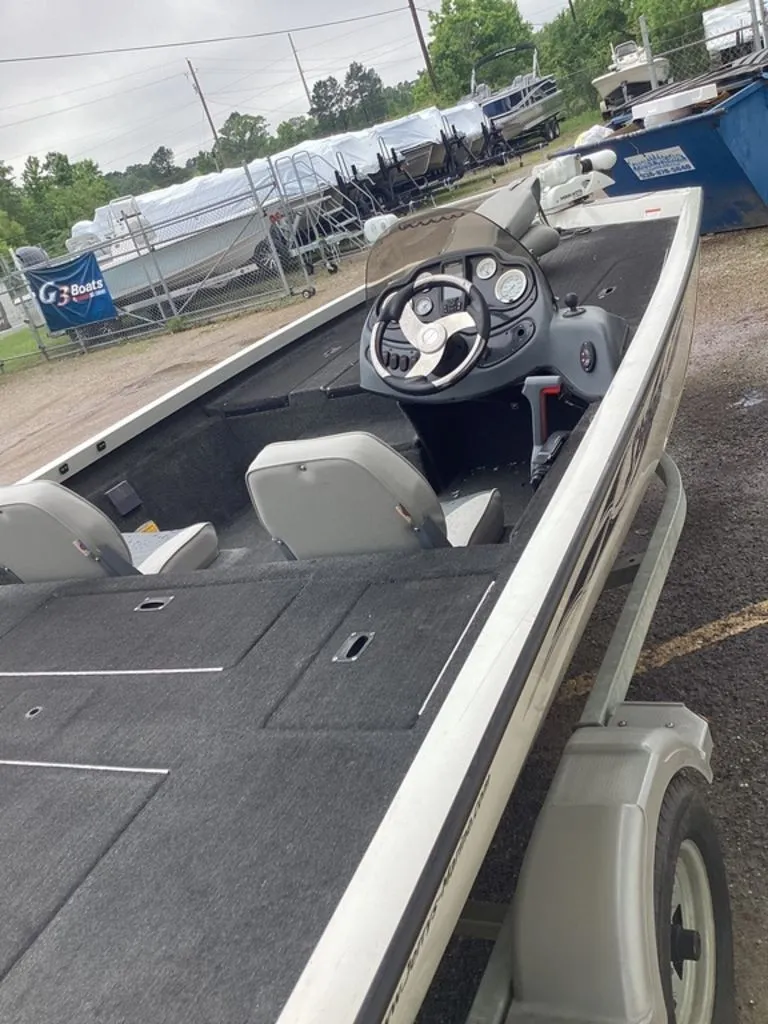 Slide: The Image of 2013 Lowe Stinger 18 HP boat on trailer outdoors. - 9