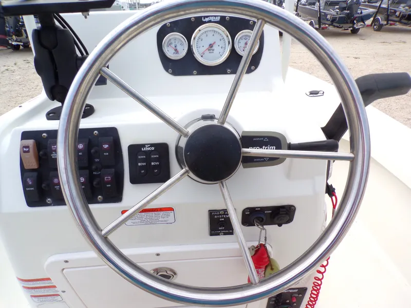 Slide: The Image of Steering wheel and dashboard of a 2022 Mako 18 LTS boat. - 30