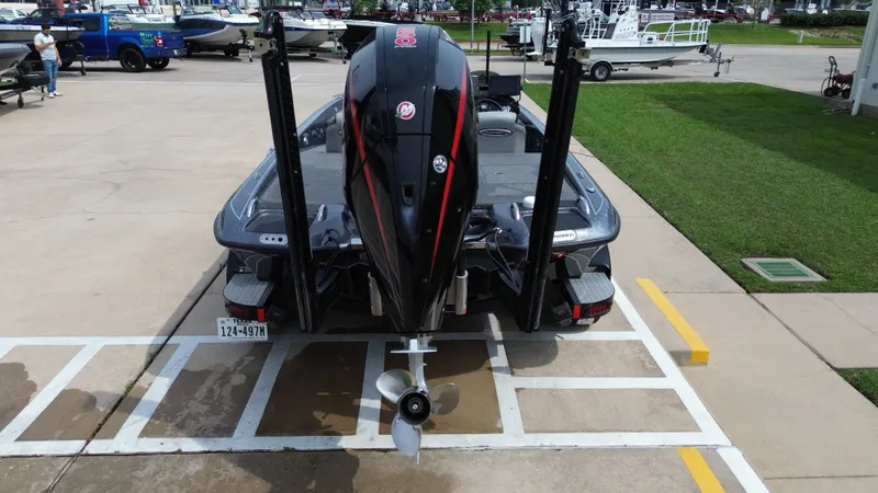 Slide: The Image of Rear view of a 2021 Phoenix 921 Elite boat in a parking area. - 34