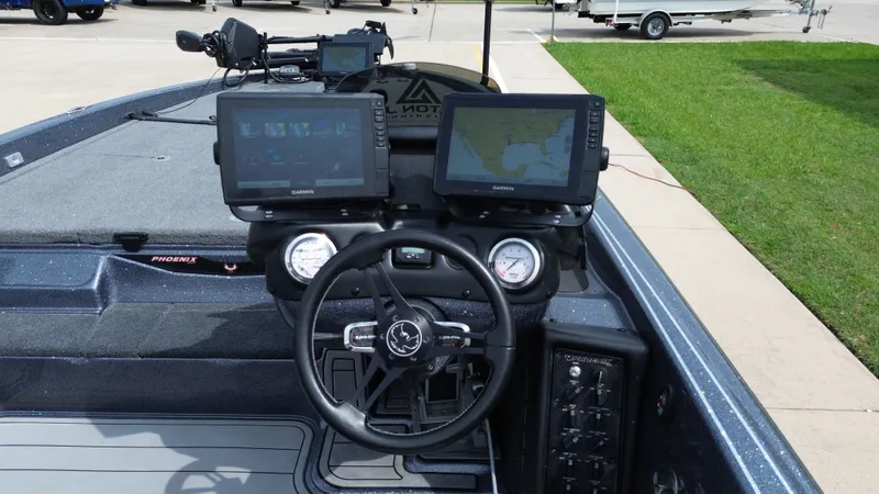 Slide: The Image of Phoenix 921 Elite 2021 boat console with Garmin displays and controls. - 35