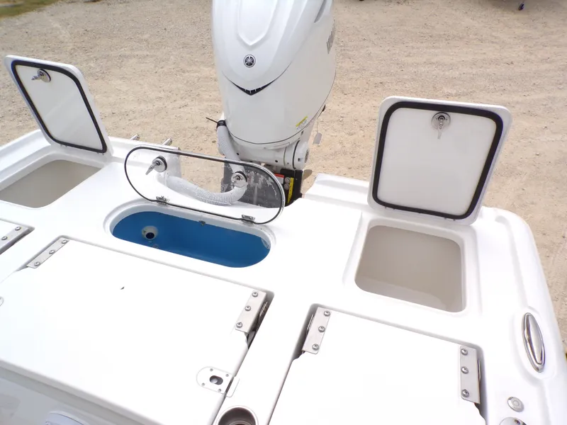 Slide: The Image of 2026 Tidewater 2500 Carolina Bay with open storage compartments and motor. - 43