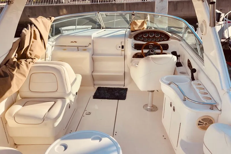 Slide: The Image of Luxurious 2001 Sea Ray 280 boat interior with plush seating and marina view. - 10