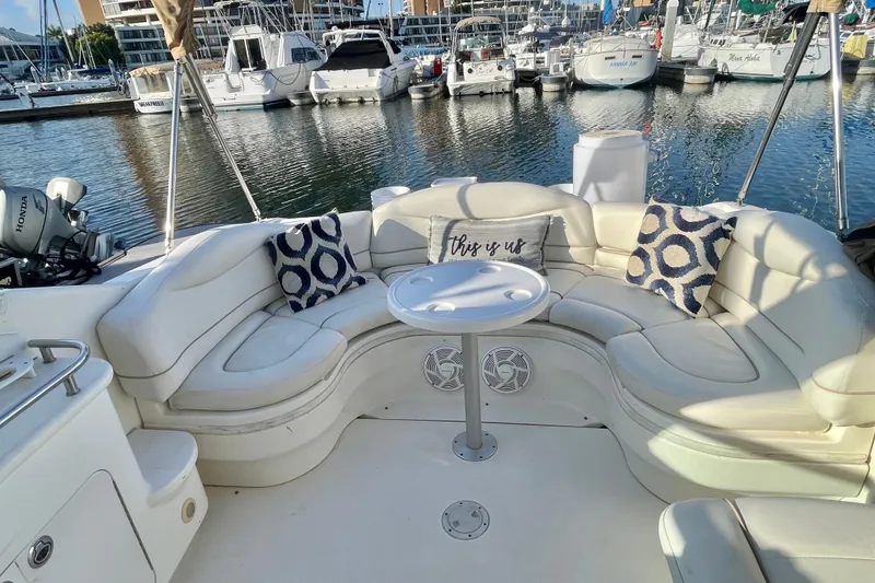 Slide: The Image of Luxurious 2001 Sea Ray 280 boat interior with plush seating and marina view. - 13