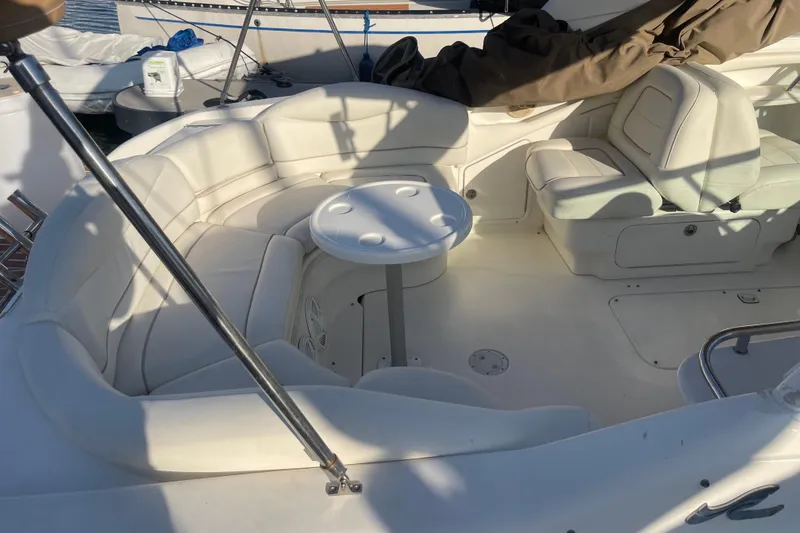 Slide: The Image of 2001 Sea Ray 280 boat interior with white seating and round table. - 15