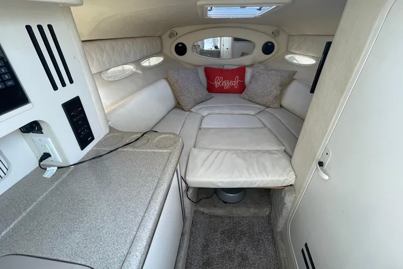 Slide: The Image of Interior cabin of a 2001 Sea Ray 280 boat with cozy seating and decor. - 16