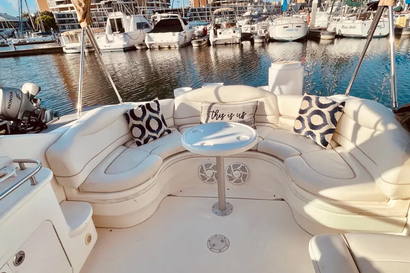 Slide: The Image of Luxurious seating area on a 2001 Sea Ray 280 boat, docked at a marina. - 22