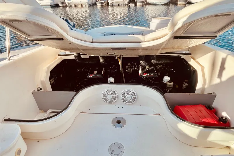 Slide: The Image of Open engine compartment of a 2001 Sea Ray 280 boat, docked at a marina. - 23