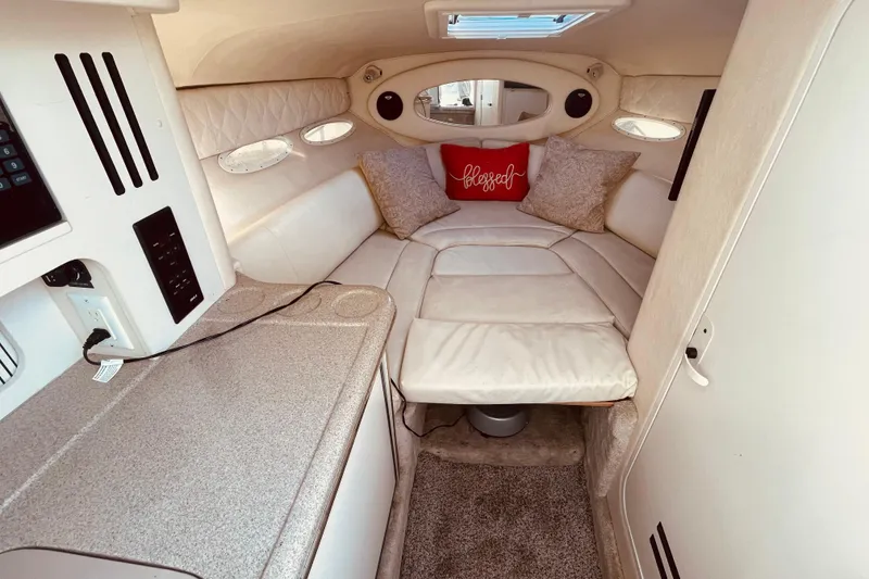 Slide: The Image of Interior of 2001 Sea Ray 280 boat with cozy seating and decorative pillows. - 24