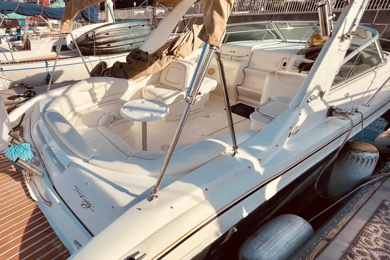 Slide: The Image of 2001 Sea Ray 280 boat with spacious seating and sleek design at a marina. - 9