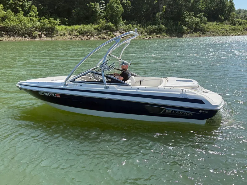 The Image of 2011 Larson LX850 boat on a calm lake. - 1