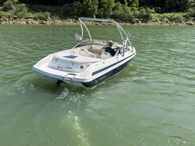 Slide: The Image of 2011 Larson LX850 boat on a calm lake. - 10