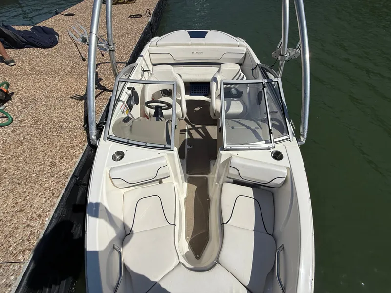 Slide: The Image of 2011 Larson LX850 boat docked at pier. - 15
