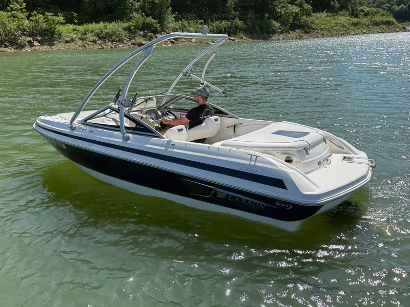 Slide: The Image of 2011 Larson LX850 motorboat on a lake. - 16
