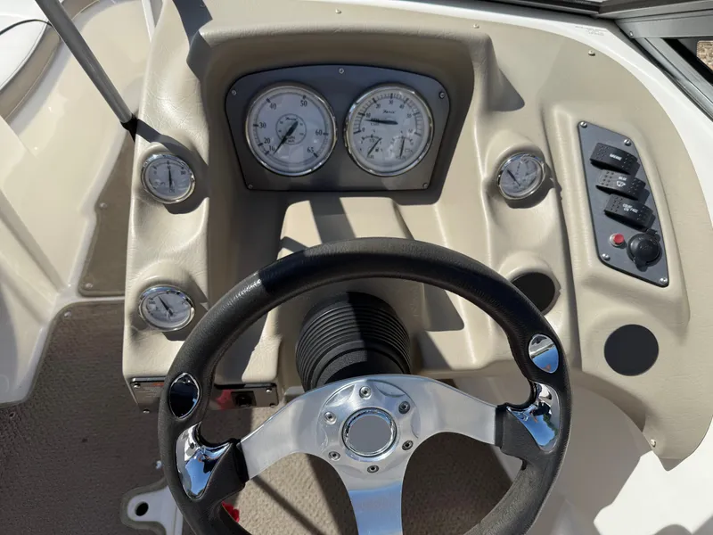 Slide: The Image of 2011 Larson LX850 boat steering console with gauges. - 18