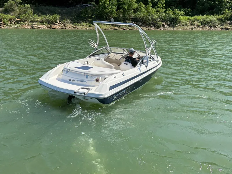 Slide: The Image of 2011 Larson LX850 boat on a calm lake. - 23