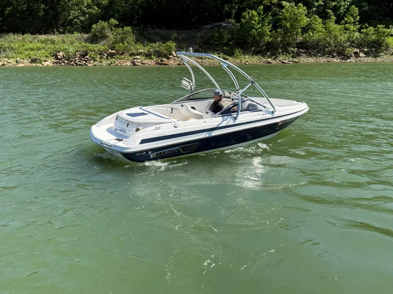 Slide: The Image of 2011 Larson LX850 boat cruising on a calm lake. - 24