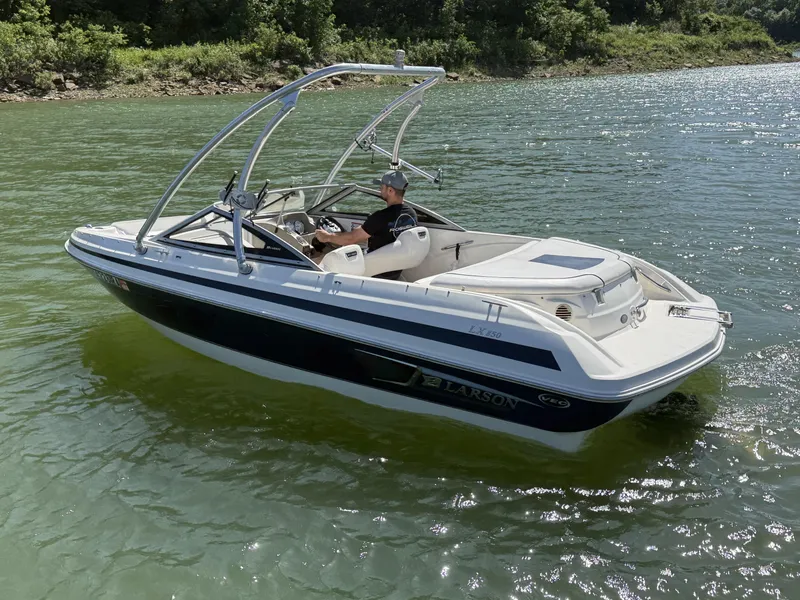 Slide: The Image of 2011 Larson LX850 boat on a calm lake. - 3