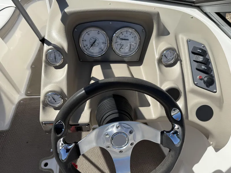 Slide: The Image of 2011 Larson LX850 boat steering console with gauges. - 5