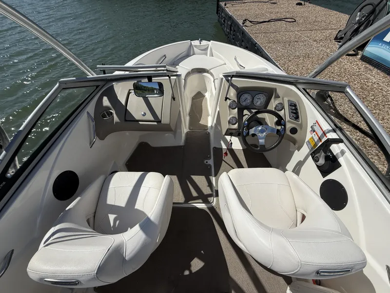 Slide: The Image of Interior of a 2011 Larson LX850 boat at the dock. - 7