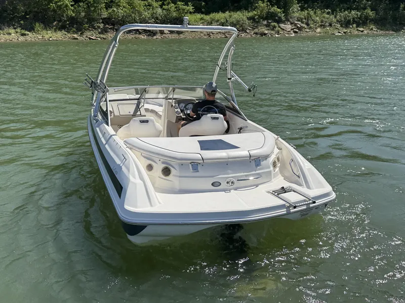 Slide: The Image of 2011 Larson LX850 boat on a lake. - 8