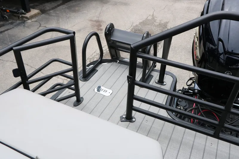 Slide: The Image of 2026 Sylvan L3 RLZ Tri Toon boat rear view with engine. - 31