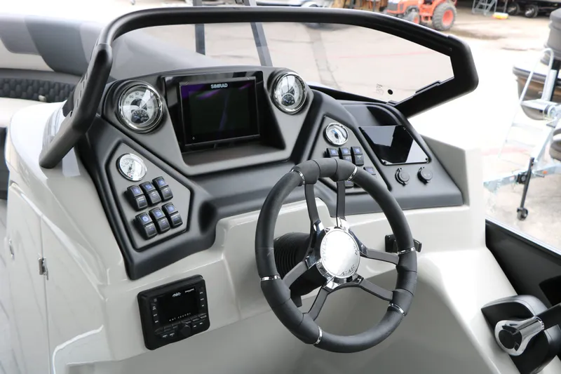 Slide: The Image of 2026 Sylvan L3 RLZ Tri Toon helm with modern controls and steering wheel. - 33