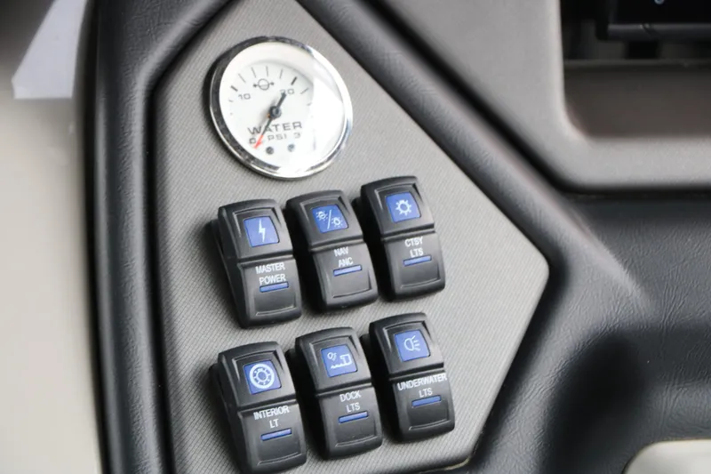 Slide: The Image of Sylvan L3 RLZ Tri Toon 2026 dashboard with switches and water gauge. - 35