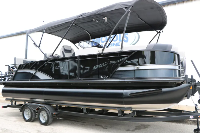 Slide: The Image of 2026 Sylvan L3 RLZ Tri Toon pontoon boat with black canopy. - 4