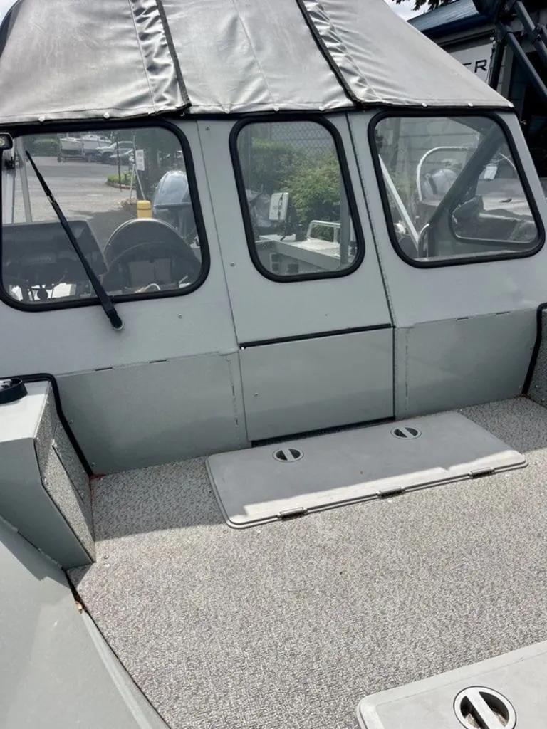 Slide: The Image of 2024 Klamath 18 OPW boat with gray canopy and windows. - 7