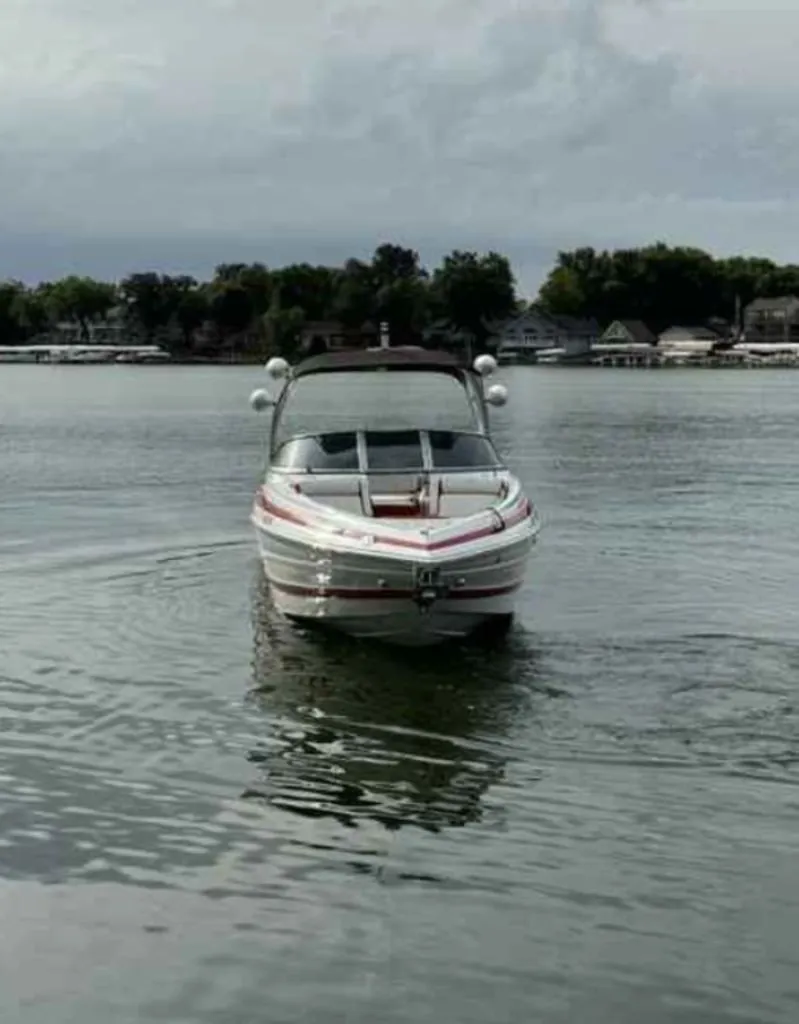 Slide: The Image of 2023 Crownline 280 SS boat on calm lake. - 2