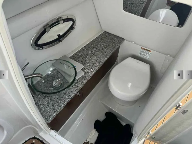 Slide: The Image of Interior of 2023 Crownline 280 SS with sink and toilet. - 9