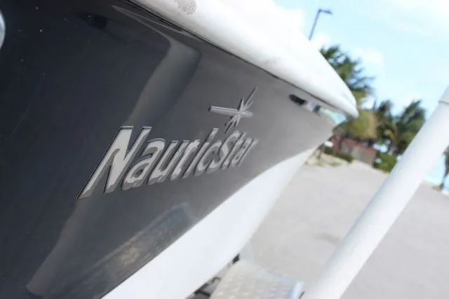 Slide: The Image of Close-up of a 2016 NauticStar 1810 boat at the beach. - 15