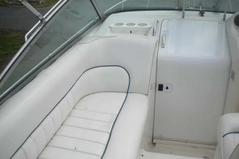 Slide: The Image of Interior view of a 1996 Sea Ray 270 Sundancer boat with white seating. - 11