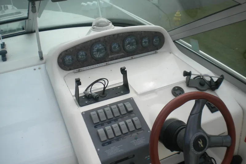 Slide: The Image of 1996 Sea Ray 270 Sundancer dashboard with gauges, switches, and steering wheel. - 13