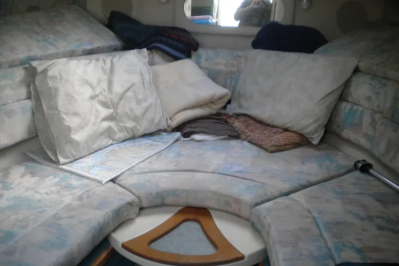 Slide: The Image of Interior cabin of a 1996 Sea Ray 270 Sundancer with cushions and a map. - 14