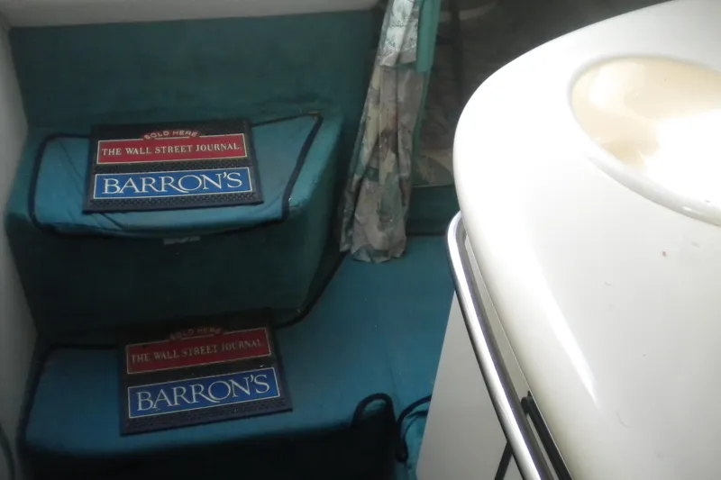 Slide: The Image of Interior of 1996 Sea Ray 270 Sundancer with magazines on teal steps. - 15