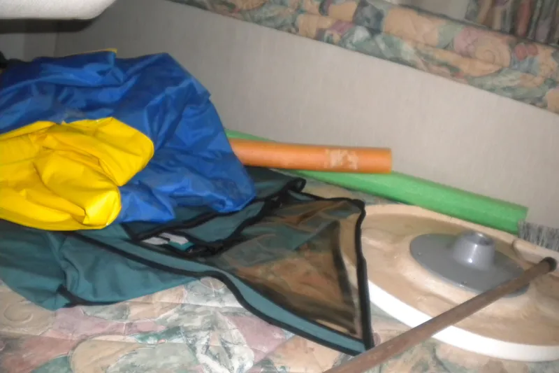 Slide: The Image of Interior of 1996 Sea Ray 270 Sundancer with pool noodles and inflatable gear. - 17