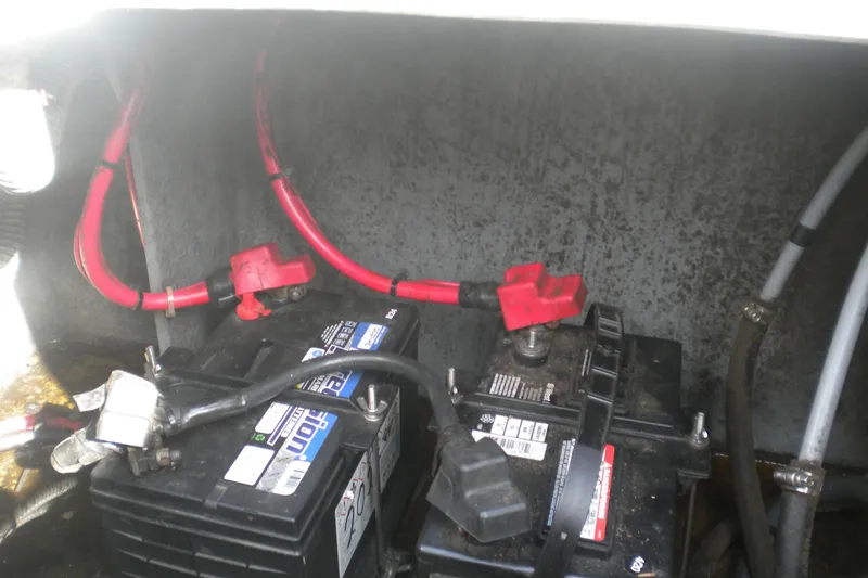 Slide: The Image of Battery compartment of a 1996 Sea Ray 270 Sundancer with red and black cables. - 23