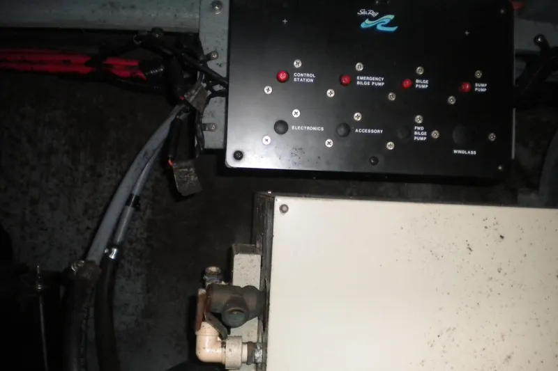Slide: The Image of Control panel of a 1996 Sea Ray 270 Sundancer boat with various switches. - 24