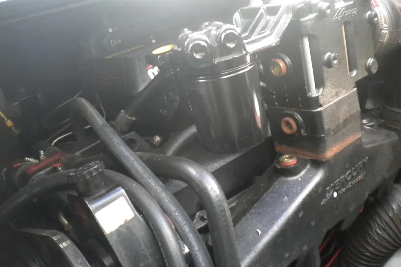 Slide: The Image of Engine components of a 1996 Sea Ray 270 Sundancer boat, featuring hoses and metal parts. - 25