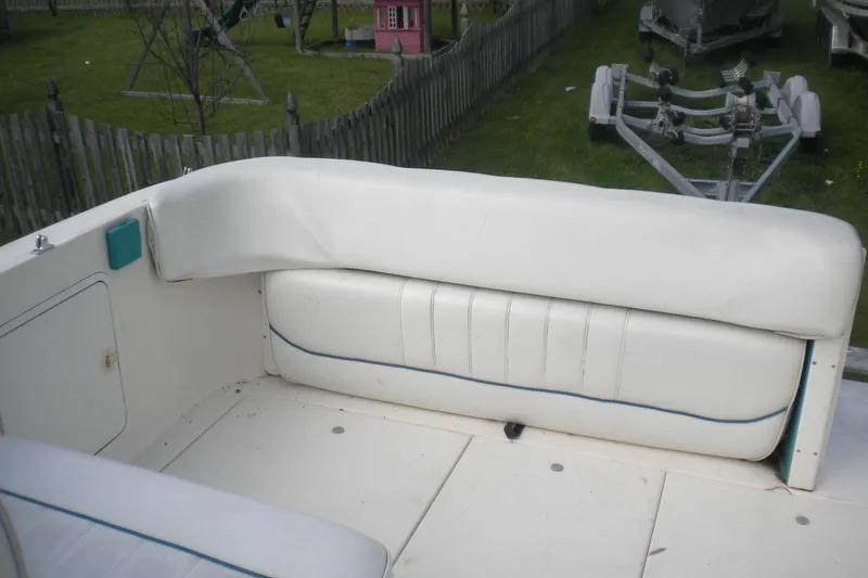 Slide: The Image of 1996 Sea Ray 270 Sundancer boat interior with white seating and outdoor setting. - 8