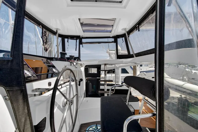 Slide: The Image of Cockpit of 2018 Lagoon 42 catamaran with steering wheel and navigation instruments. - 12