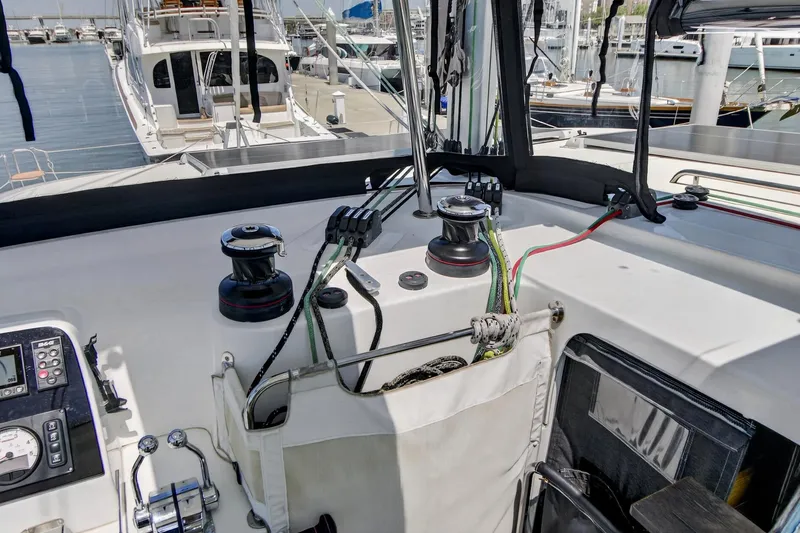 Slide: The Image of Cockpit of 2018 Lagoon 42 catamaran with winches and control panel at marina. - 15
