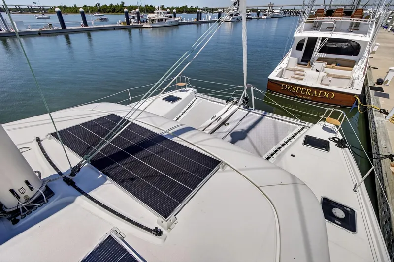 Slide: The Image of 2018 Lagoon 42 catamaran with solar panels docked at marina. - 17