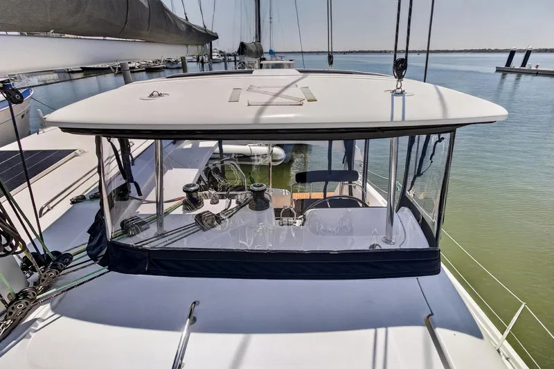 Slide: The Image of 2018 Lagoon 42 catamaran with sleek design, docked at marina, featuring modern sailing equipment. - 19