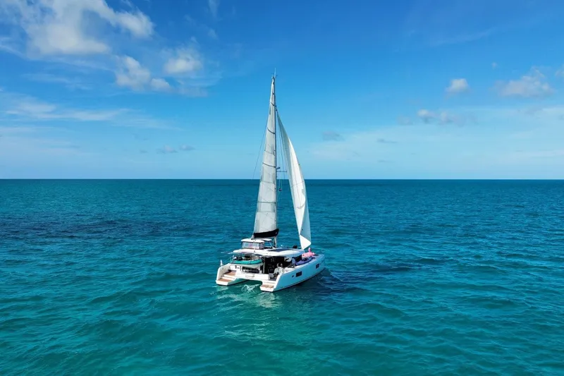 Slide: The Image of Sailing Lagoon 42 catamaran, 2018 model, on clear blue ocean under sunny skies. - 2