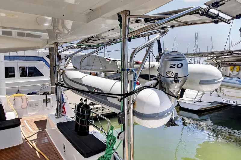 Slide: The Image of 2018 Lagoon 42 yacht with dinghy and outboard motor docked at marina. - 22
