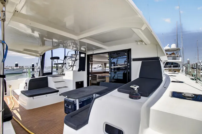 Slide: The Image of Spacious deck of 2018 Lagoon 42 catamaran with seating and helm station. - 25