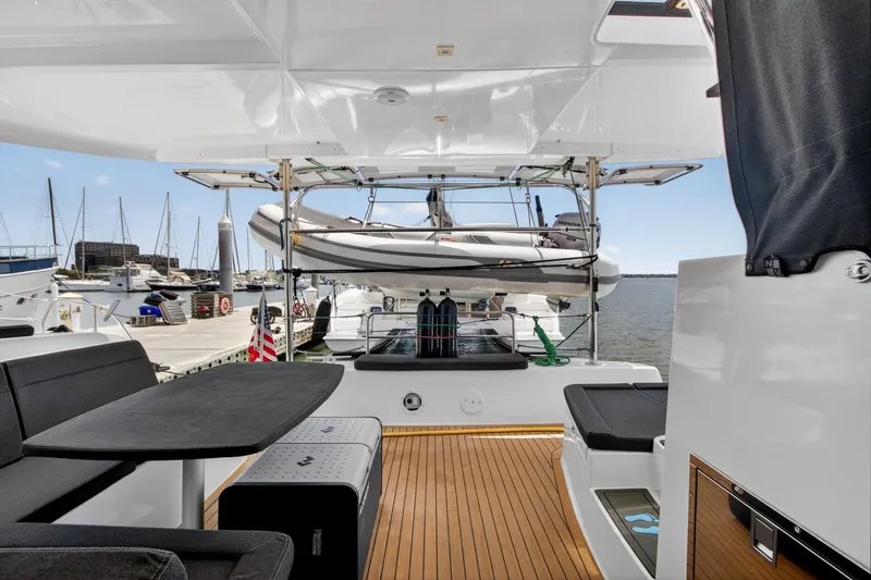 Slide: The Image of 2018 Lagoon 42 yacht interior with sleek seating and dock view. - 27