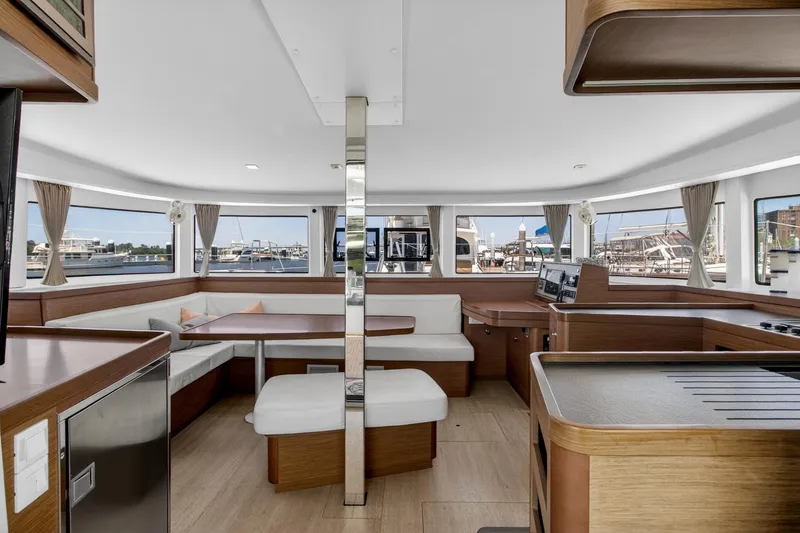 Slide: The Image of Luxurious interior of 2018 Lagoon 42 catamaran with panoramic windows and modern furnishings. - 29